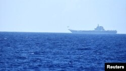 FILE - A helicopter takes off from China's Shandong aircraft carrier over Pacific Ocean waters south of Okinawa prefecture, Japan, in this handout photo taken April 15, 2023, and released by the Joint Staff Office of the Defense Ministry of Japan.