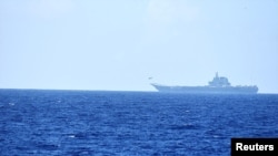 FILE - A helicopter takes off from China's Shandong aircraft carrier over Pacific Ocean waters south of Okinawa prefecture, Japan, in this handout photo taken April 15, 2023, and released by the Joint Staff Office of the Defense Ministry of Japan.