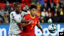 Haiti's Batcheba Louis, left, fights for the ball with China's Wang Shuang during the Women's World Cup Group D soccer match between China and Haiti in Adelaide, Australia, July 28, 2023. 