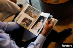 Yakov Argamani, father of hostage Noa Argamani, 26, who was filmed as she was being abducted during the deadly Oct. 7 attack by Palestinian Islamist group Hamas, looks through photographs of Noa as a child, in Tel Aviv, Israel, Nov. 23, 2023.