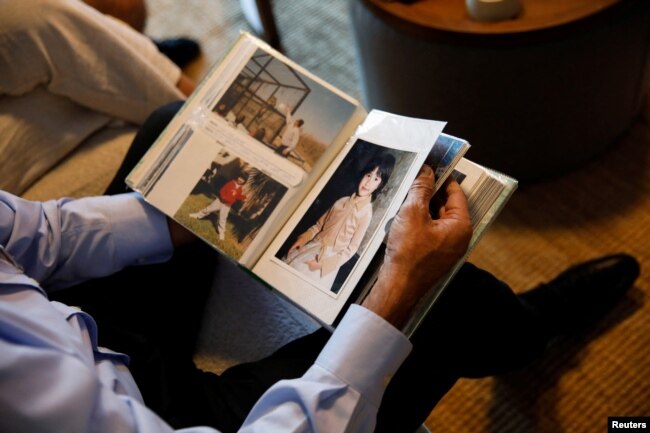 Yakov Argamani, father of hostage Noa Argamani, 26, who was filmed as she was being abducted during the deadly Oct. 7 attack by Palestinian Islamist group Hamas, looks through photographs of Noa as a child, in Tel Aviv, Israel, Nov. 23, 2023.
