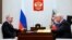 FILE - Russian President Vladimir Putin, left, listens to Sergey Mironov, the leader of political party A Just Russia in Moscow, on Feb. 14, 2023. (Mikhail Metzel, Sputnik, Kremlin Pool Photo via AP)