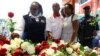 Private security guards place roses outside the Westgate shopping mall, on the 10th commemoration since the Somali militant group al-Shabaab attacked the mall killing at least 67 people, in Nairobi, Kenya, Sept. 21, 2023.