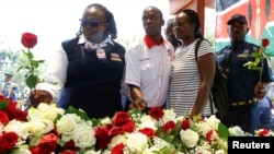 Private security guards place roses outside the Westgate shopping mall, on the 10th commemoration since the Somali militant group al-Shabaab attacked the mall killing at least 67 people, in Nairobi, Kenya, Sept. 21, 2023.
