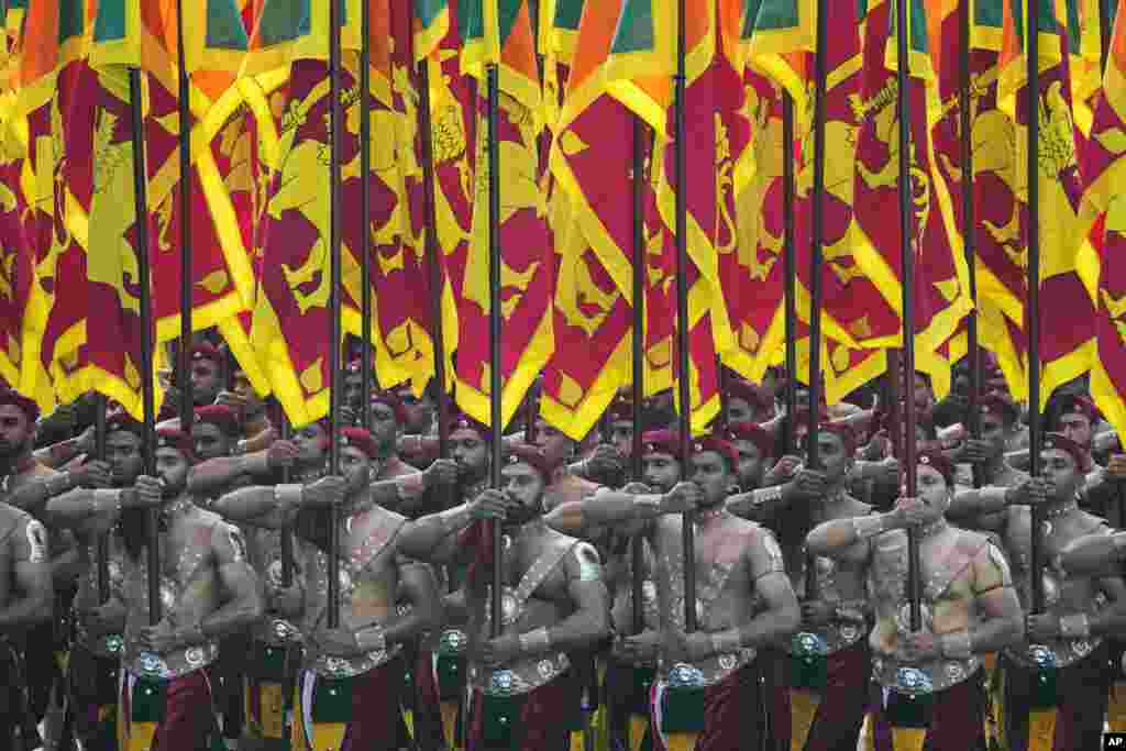 Sri Lankan soldiers march during the country&#39;s 76th Independence Day commemoration ceremony in Colombo.