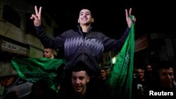 Released Palestinian prisoners react as they leave the Israeli military prison, Ofer, after a hostages-prisoners swap deal between Hamas and Israel, near Ramallah in the Israeli-occupied West Bank, Nov. 24, 2023.