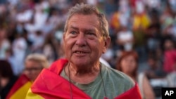A supporter of VOX far-right party wrapped in a Spanish flag attends an election campaign event in Guadalajara, Spain, July 15, 2023. 
