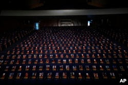 FILE - Photographs of over 1,000 persons killed, missing or abducted in the Hamas attack on Israel on October 7 are displayed on empty seats in an exhibit in the Smolarz Auditorium at Tel Aviv University, Oct. 22, 2023.