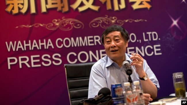 FILE - Zong Qinghou, once China's richest person, smokes as he speaks to journalists during a news conference in Beijing, China, July 17, 2013.