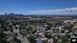 Trees dot the working class neighborhood of Globeville in Denver, July 24, 2023. Temperatures are hotter in low-income neighborhoods which have less vegetation which cools the area.