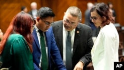 From left, Democratic Arizona Reps. Melody Hernandez, Oscar De Los Santos, Lupe Contreras and Nancy Gutierrez confer, April 17, 2024, at the Capitol in Phoenix. House Republicans again blocked an effort to repeal a near-total ban on abortions.