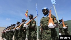 (FILE) Ugandan peacekeeping troops stand during a ceremony at Mogadishu airport in Somalia in 2014.