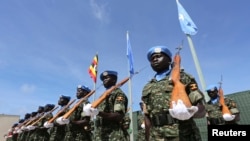 FILE - Ugandan peacekeeping troops stand during a ceremony at Mogadishu airport in Somalia, May 18, 2014.