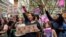 FILE - People chant as striking NHS healthcare staff take part in a protest march amid an ongoing dispute with the government over pay, in London, May 1, 2023. 