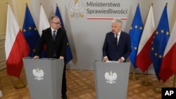 FILE - European Commissioner for Justice Didier Reynders, right, and Poland's new Justice Minister Adam Bodnar speak at a news conference at the Justice Ministry in Warsaw, Poland, Jan. 19, 2024.