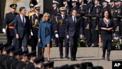 French President Emmanuel Macron, center right, his wife Brigitte Macron, Dutch Prime Minister Mark Rutte, left, and Amsterdam mayor Femke Halsema, right, arrive for a wreath-laying ceremony in Amsterdam, Netherlands, April 11, 2023.