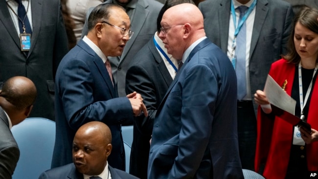 FILE - Zhang Jun, China's ambassador to the U.N., left, speaks with Vassily Nebenzia, Russia's Permanent Representative to the U.N., as U.N. Security Council members gathered before going into closed consultations at U.N. headquarters, Oct. 16, 2023.