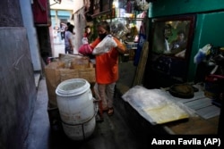 Capentes said the trash used to be mixed together until a local environmental nonprofit asked people to separate it. (AP Photo/Aaron Favila)