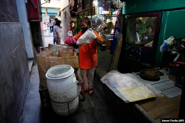 Capentes said the trash used to be mixed together until a local environmental nonprofit asked people to separate it. (AP Photo/Aaron Favila)