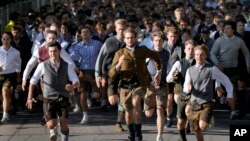 People run to enter the 188th 'Oktoberfest' beer festival in Munich, Sept. 16, 2023.