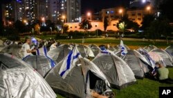 Thousands of marchers who completed the last leg of a four-day, 70-kilometer trek from Tel Aviv to Israel's parliament to protest Prime Minister Benjamin Netanyahu's plan to overhaul to country's judiciary set up camp outside the Knesset, Israel's parliament, in Jerusalem, July 22, 2023.