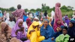 Nigerian Muslim women and children attend Eid al-Adha prayers at an open field in Lagos, June 28, 2023