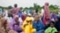 Nigerian Muslim women and children attend Eid al-Adha prayers at an open field in Lagos, June 28, 2023