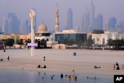 People swim during a sweltering summer in Dubai, United Arab Emirates, July 5, 2023.