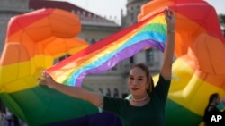 A participant holds a rainbow flag at government house in Bangkok, Thailand, June 18, 2024. Thailand’s Senate voted overwhelmingly on Tuesday to approve a marriage equality bill.