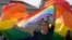 A participant holds a rainbow flag at government house in Bangkok, Thailand, June 18, 2024. Thailand’s Senate voted overwhelmingly on Tuesday to approve a marriage equality bill.