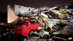 A car is buried under rubble on Main Street after a tornado hit Hendersonville, Tenn., Dec. 9, 2023.