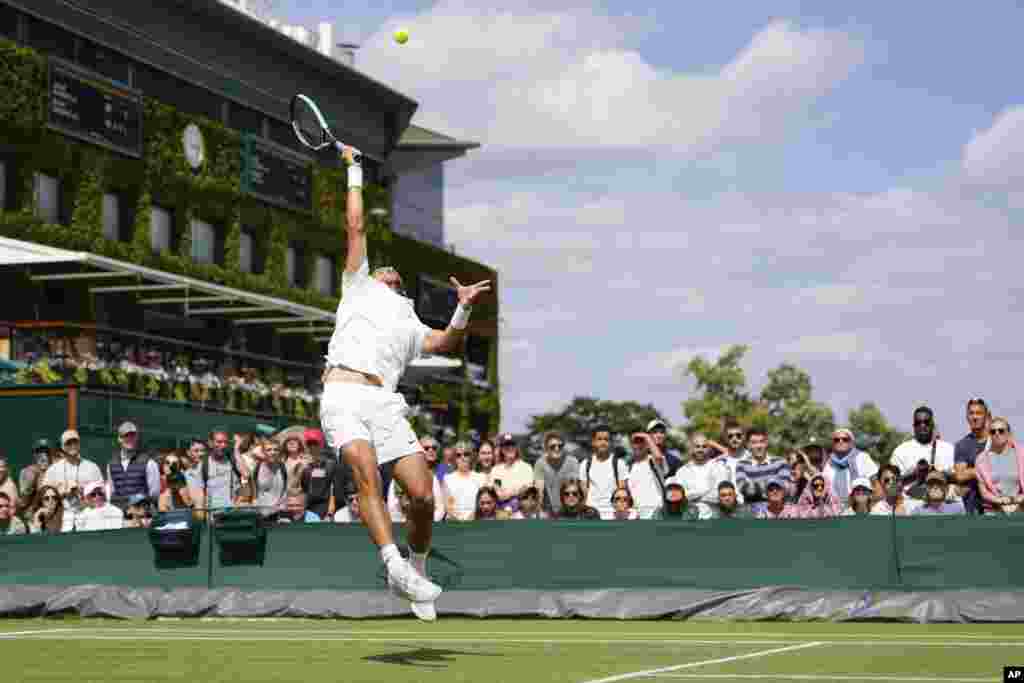 Lorenzo Musetti plays a forehand return to compatriot Luciano Darderi during their second round match at the Wimbledon tennis championships in London.