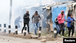 Supporters of Kenya's opposition leader Raila Odinga run after riot police officers lobbed teargas to disperse them during an anti-government protest in Nairobi, Kenya July 7, 2023.