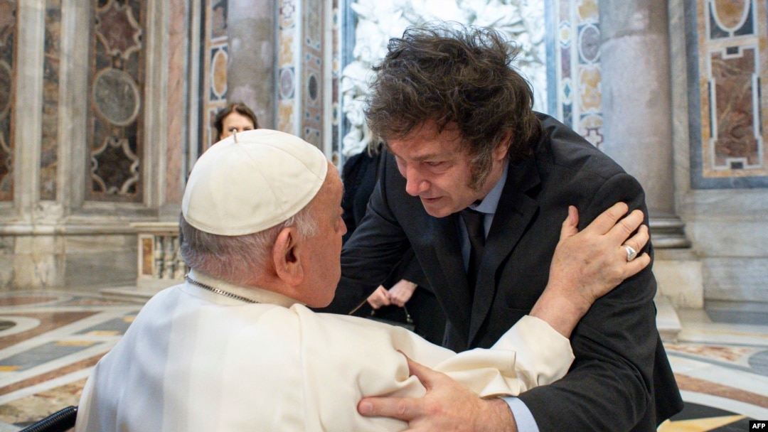 This handout photograph taken on Feb. 11, 2024 and released by the Vatican press office, Vatican Media, shows Pope Francis (L) greeting Argentine President Javier Milei (R) at the Vatican. (Photo by Handout / Vatican Media / AFP)