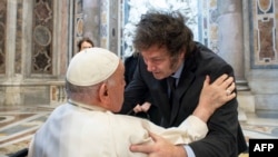 This handout photograph taken on Feb. 11, 2024 and released by the Vatican press office, Vatican Media, shows Pope Francis (L) greeting Argentine President Javier Milei (R) at the Vatican. (Photo by Handout / Vatican Media / AFP)