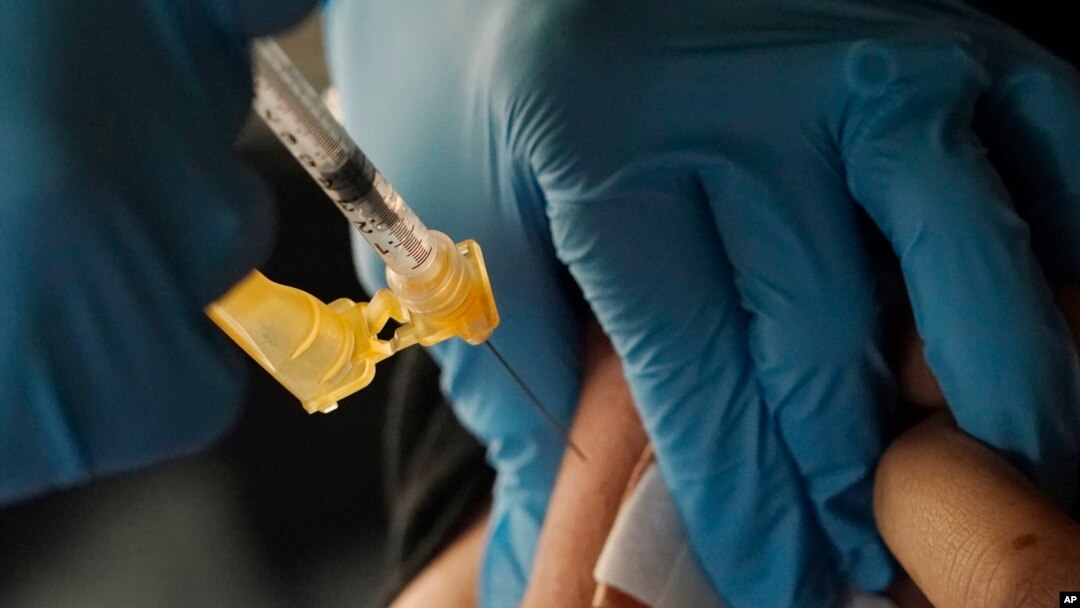 FILE - A nurse administers a Moderna COVID-19 booster vaccine in Jackson, Mississippi, Nov. 18, 2022. This week, U.S. regulators cleared another COVID-19 booster dose for older adults and people with weak immune systems.