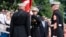 U.S. Marine Corps Gen. David Berger, left, hands the battle colors to Gen. Eric Smith during a relinquishment of office ceremony, at the Marine Barracks in Washington, July 10, 2023. 