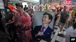 Supporters of the Move Forward Party hold a portrait of Pita Limjaroenrat, the party's leader, during a protest in Bangkok, Thailand, July 23, 2023.