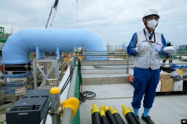 Tomohiko Mayuzumi, a spokesperson of Tokyo Electric Power Company Holdings, also known as TEPCO, speaks during a tour of the Fukushima Daiichi nuclear power plant in Futaba town, Japan, July 14, 2023.