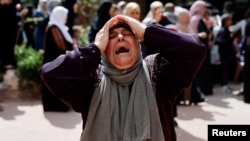 FILE — A woman mourns at the funeral of four Palestinians killed in clashes with Israeli settlers, near Nablus in the Israeli-occupied West Bank, Oct. 12, 2023.