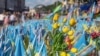 Tulips are placed among Ukrainian flags in memory of fallen fighters, in Kyiv, Ukraine, June 25, 2024.