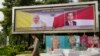 A person walks past a welcoming banner bearing portraits of Pope Francis and Indonesian President Joko Widodo ahead of the pope's visit to Indonesia, in Jakarta, Indonesia, Sept. 3, 2024.