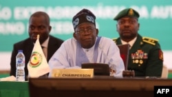 FILE - Nigerian President Bola Tinubu, center, pauses while addressing ECOWAS heads of state and government in Abuja, Nigeria, July 30, 2023.