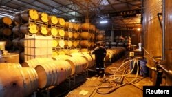 FILE - A worker prepares barrels for wine storage at Nederburg Wine Estate in Paarl, South Africa, July 8, 2020. Business leaders in South Africa worry about how the country's deteriorating relationship with the U.S. will impact the economy.
