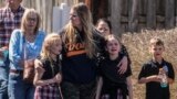 Children and a woman depart the reunification center at the Woodmont Baptist church after a school shooting in Nashville, Tennessee, March 27, 2023.
