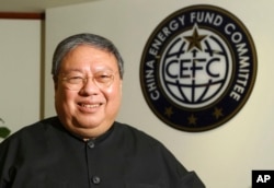FILE - Patrick Ho, former Hong Kong home affairs secretary and deputy chairman of a non-governmental organization funded by CEFC China Energy, smiles during an interview in Hong Kong, July 2015.