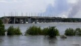 This general view shows a partially flooded area near the Antonovskiy Bridge on the outskirts of Kherson, Ukraine, June 6, 2023, following the collapse of the Kakhovka hydroelectric dam. 