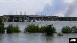 This general view shows a partially flooded area near the Antonovskiy Bridge on the outskirts of Kherson, Ukraine, June 6, 2023, following the collapse of the Kakhovka hydroelectric dam. 