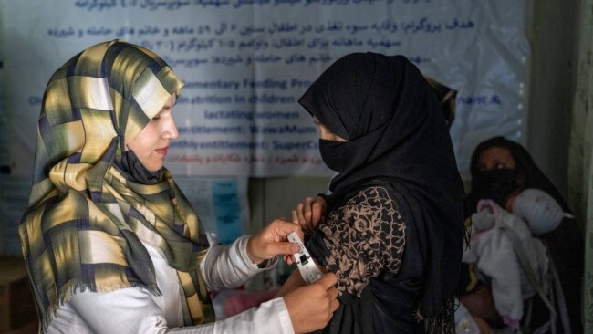 FILE - An Afghan woman is checked by a nutritionist at a clinic run by the United Nations' World Food Programme, in Kabul, Afghanistan, Jan. 26, 2023.