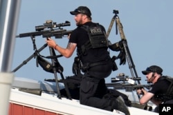 Police snipers return fire after shots were fired while Republican presidential candidate former President Donald Trump was speaking at a campaign event in Butler, Pennsylvania, July 13, 2024.